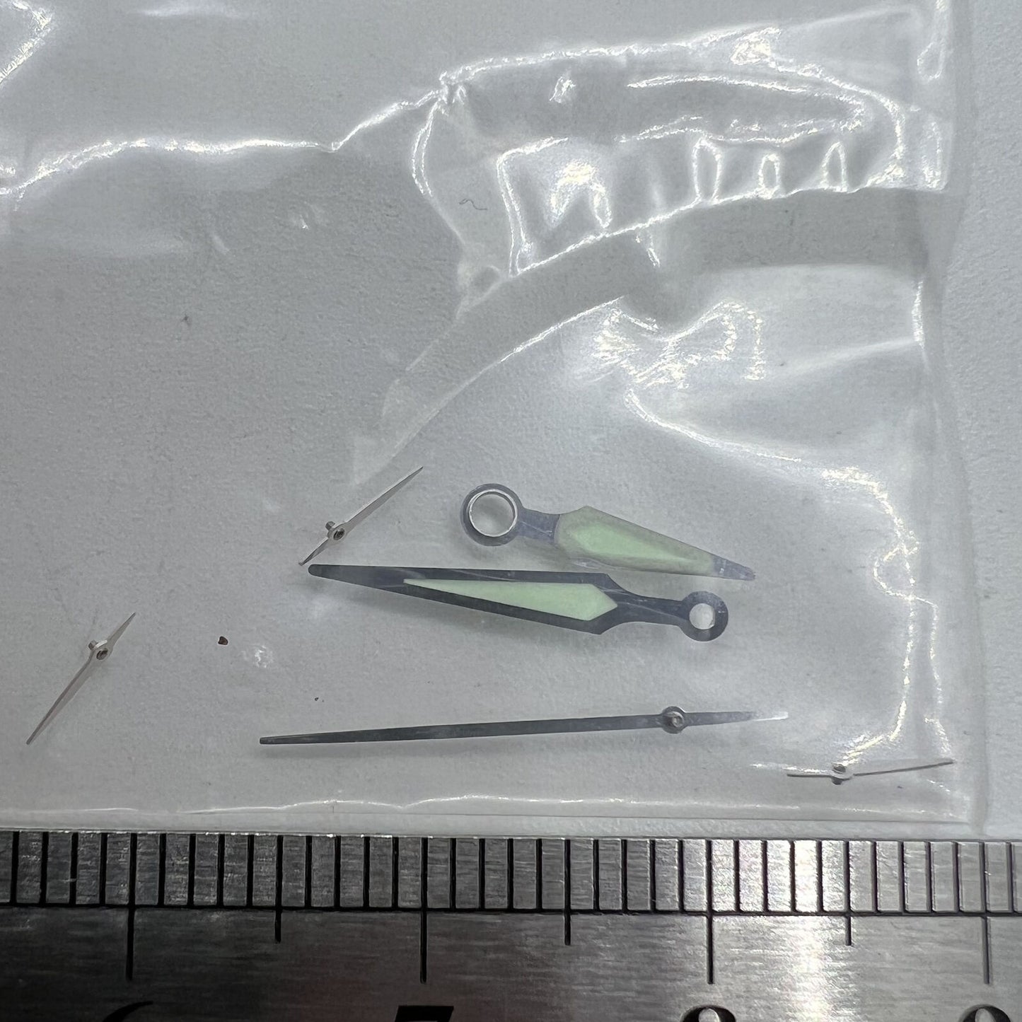 Silver-trimmed luminous watch hands for ETA G10.211 quartz movement, enhancing readability in low light.