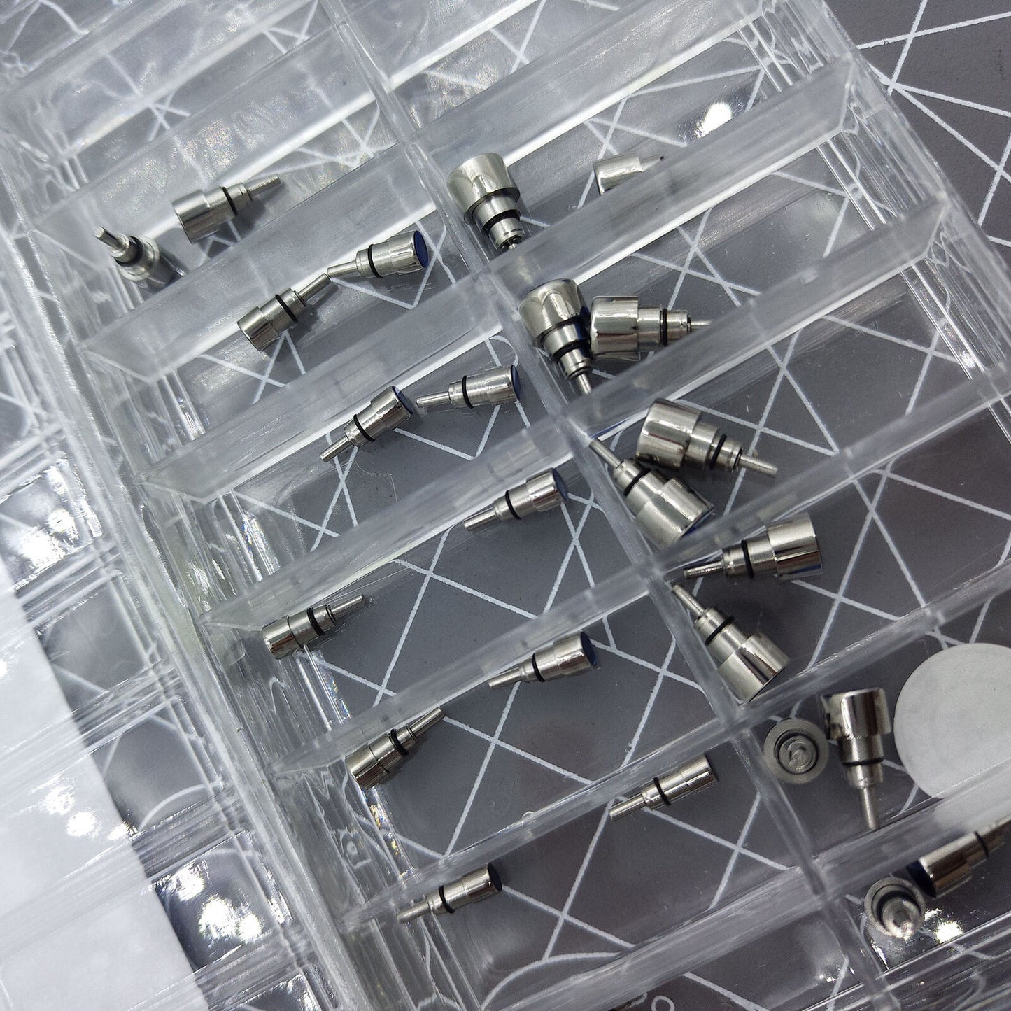 Classical stainless steel chronograph and screw-in watch pushers set for repairs.