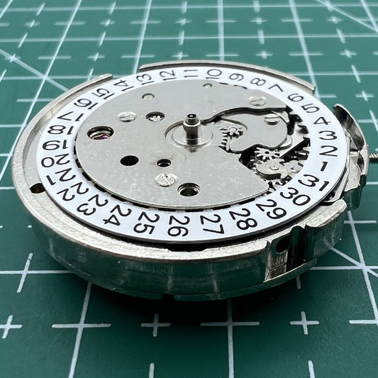 Close-up of Wholesale 26.5mm 7120 Mechanical Movement watch with single calendar and three hands.