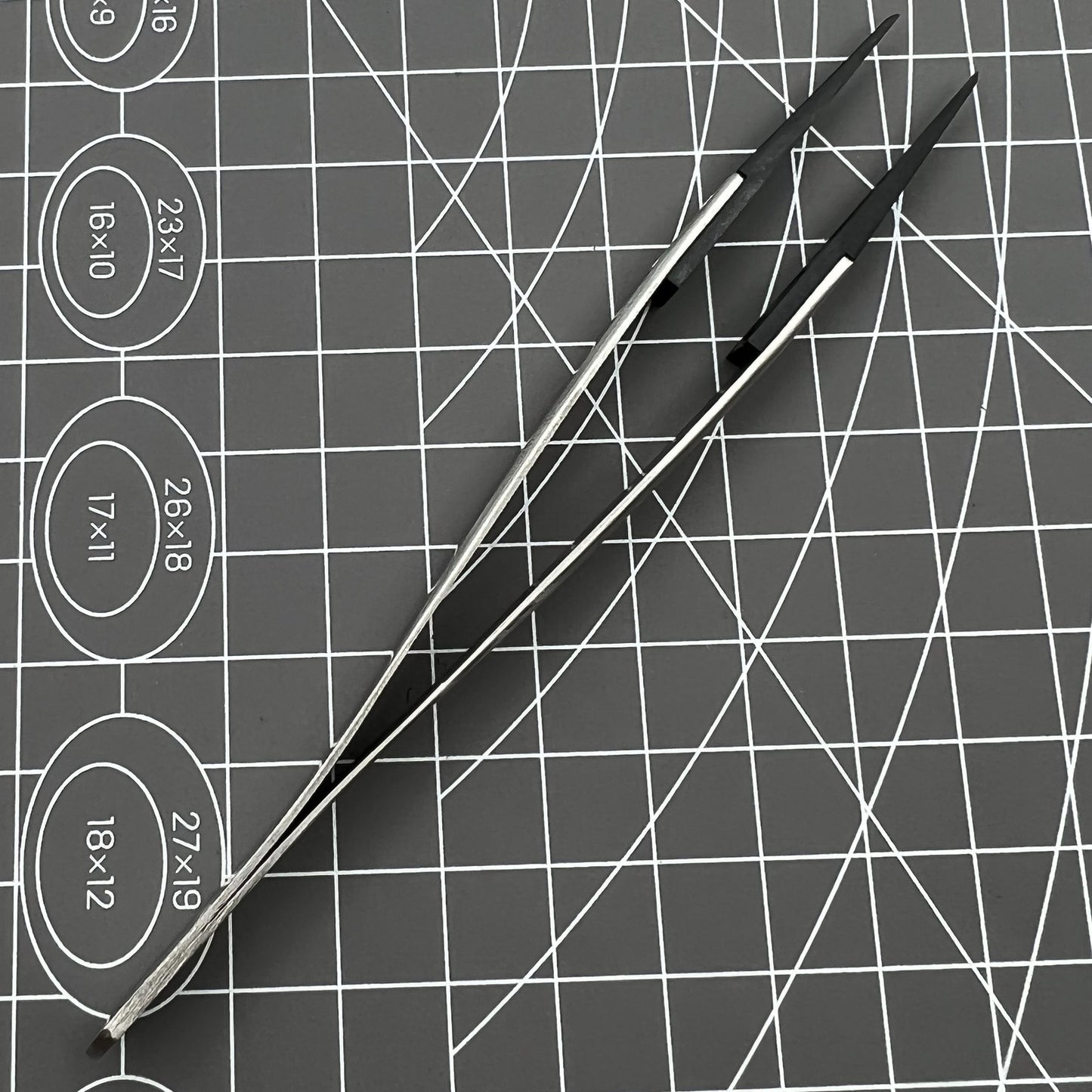 Stainless steel Carbon Fiber Head Tweezers for precise watch repair tasks.