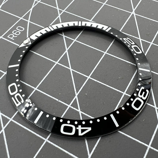 38mm black ceramic bezel, polished finish, waterproof design for men's watches.