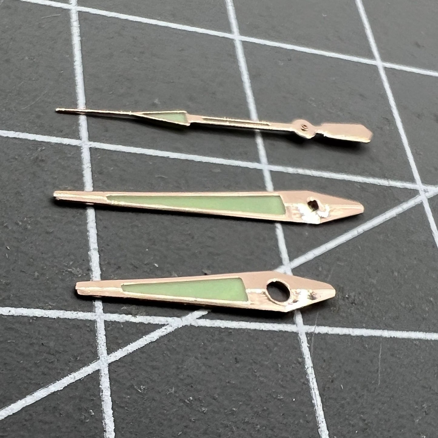 Rose Golden 14mm arrow-shaped luminous watch hands by ISA, enhancing green visibility and precise time reading.