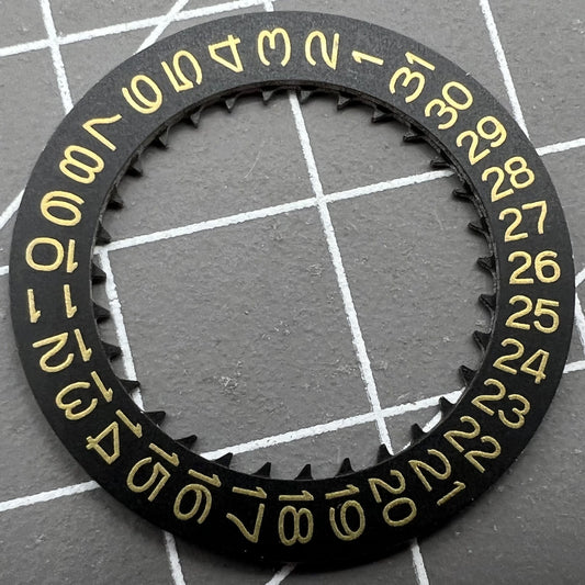 Golden character date wheel for NH35/NH36 movement on black background, precision watch accessory.