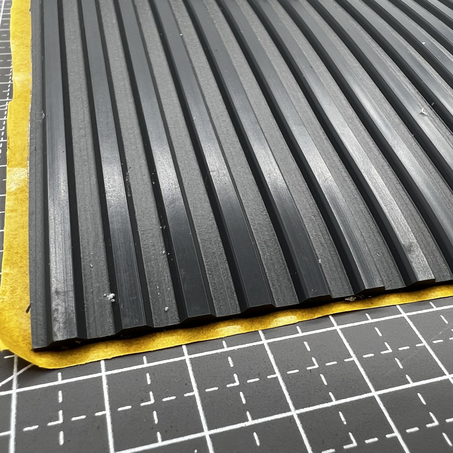 Swiss Bergeon grooved bench mat for watch repair, durable self-adhesive surface enhancing precision tasks.