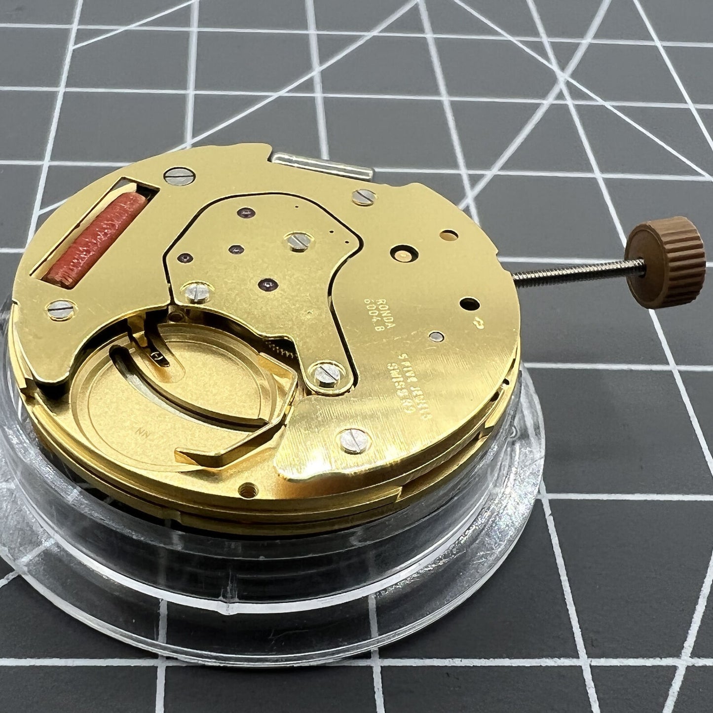 Golden Swiss Made Ronda 6004B quartz watch movement with date at 12 o'clock, precise and reliable by Ronda.