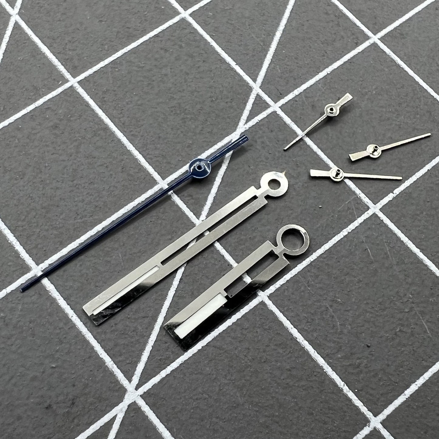 Luminous silver watch hands by Ronda for 5021D quartz movement, perfect for precise watch repairs.