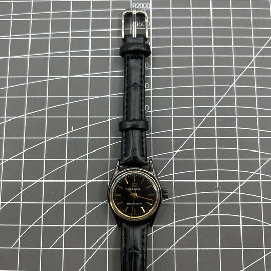 27mm Tianjin Seagull ladies watch with manual mechanical movement and golden nail hour markers.