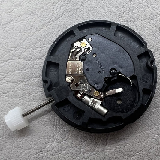 Swiss ETA 805.144 quartz movement watch mechanism with three hands on a silver white disk by ETA.