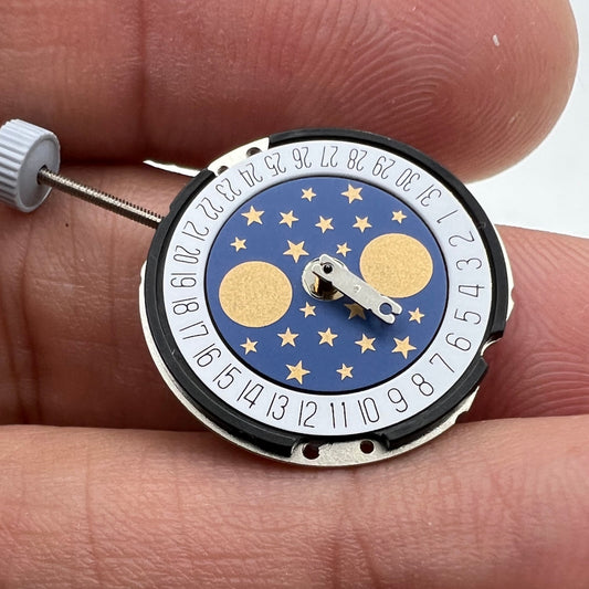 Ronda 788 Swiss quartz watch movement with date at 6, moon phase, and three hands for precise timekeeping.
