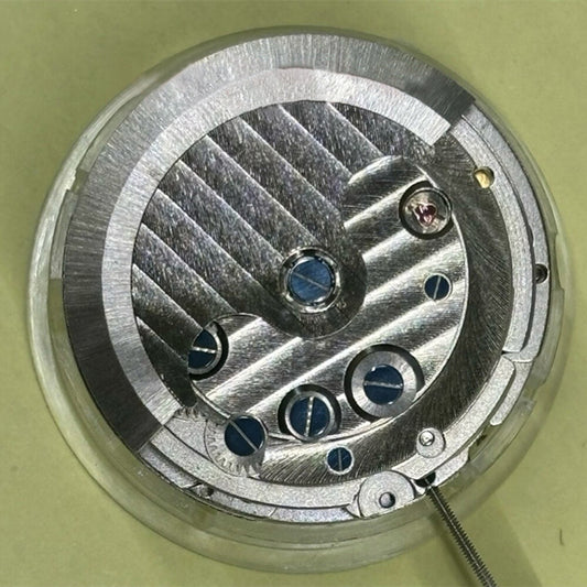 Shanghai brand mechanical watch movement with bare balance wheel and visible 6 o'clock flywheel detail.