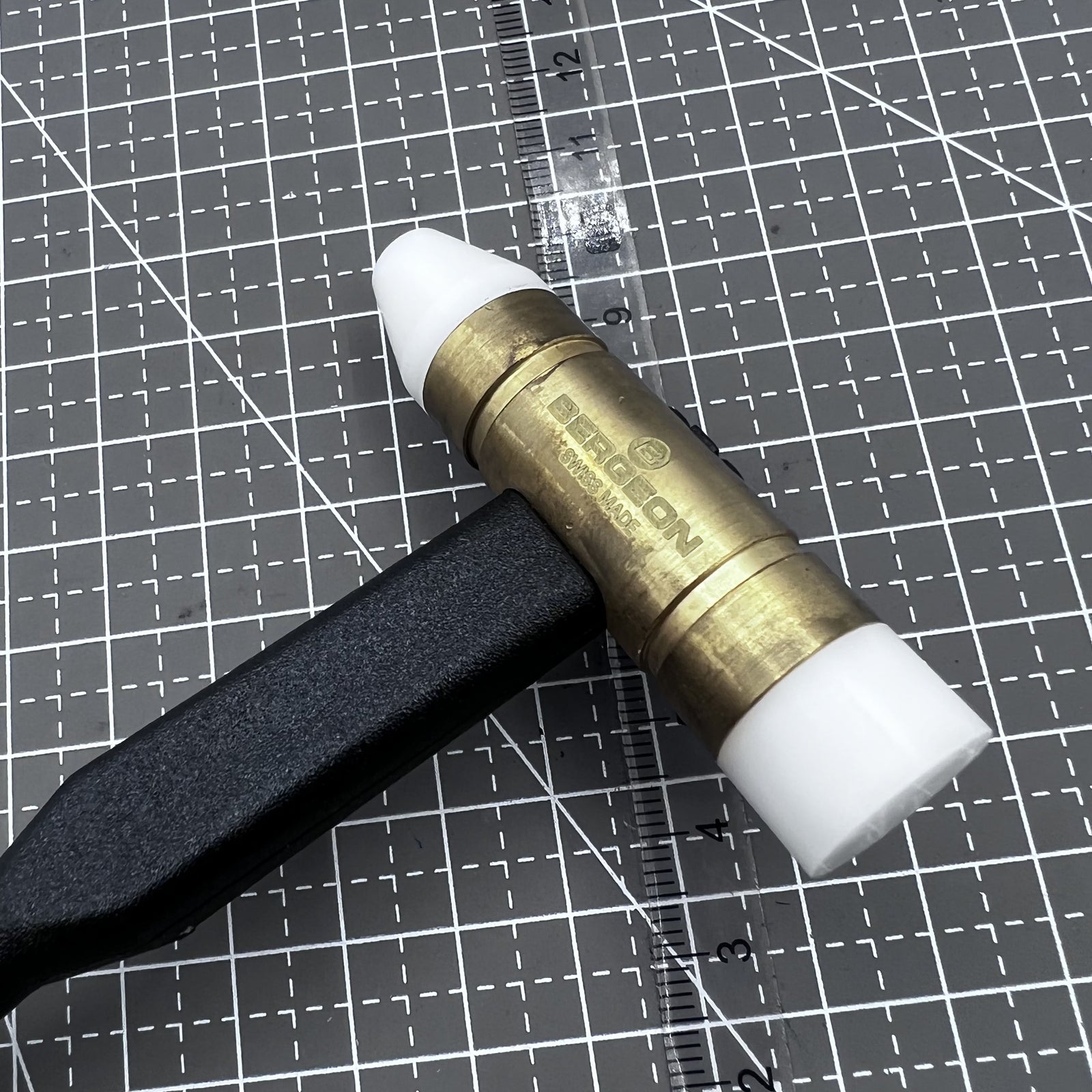 Swiss Bergeon 30516 watchmaker hammer with plastic handle and interchangeable tips for precise watch repairs and adjustments.