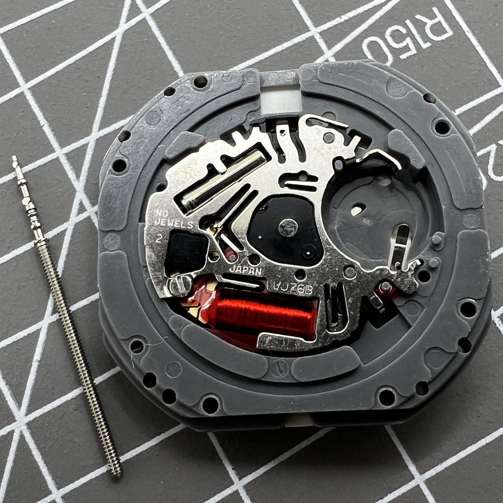 Hattori Epson TMI VJ76 quartz watch movement with dual date windows at 6 and 12 o'clock for accurate timekeeping.