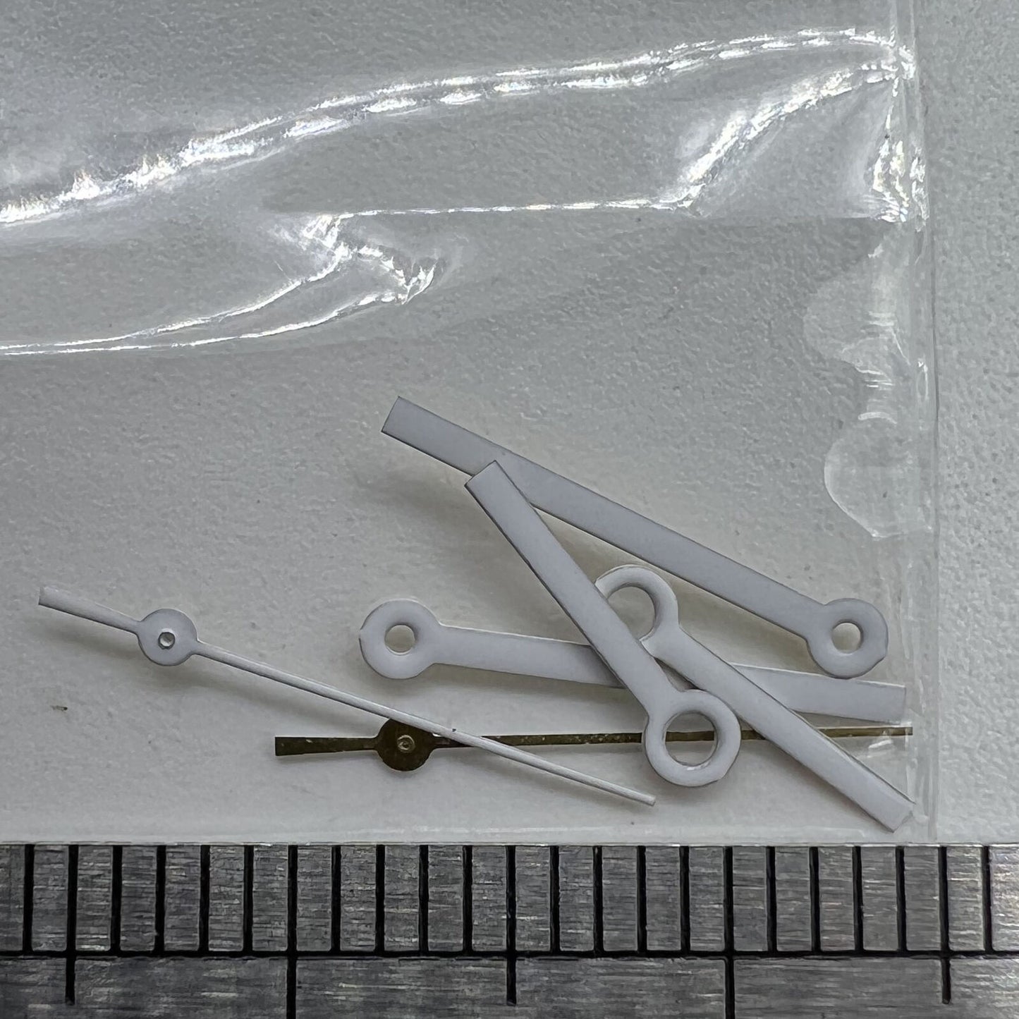 White watch hands set for Miyota 2035 movement, precise fit 15x13x9mm, branded quality for accurate timekeeping.