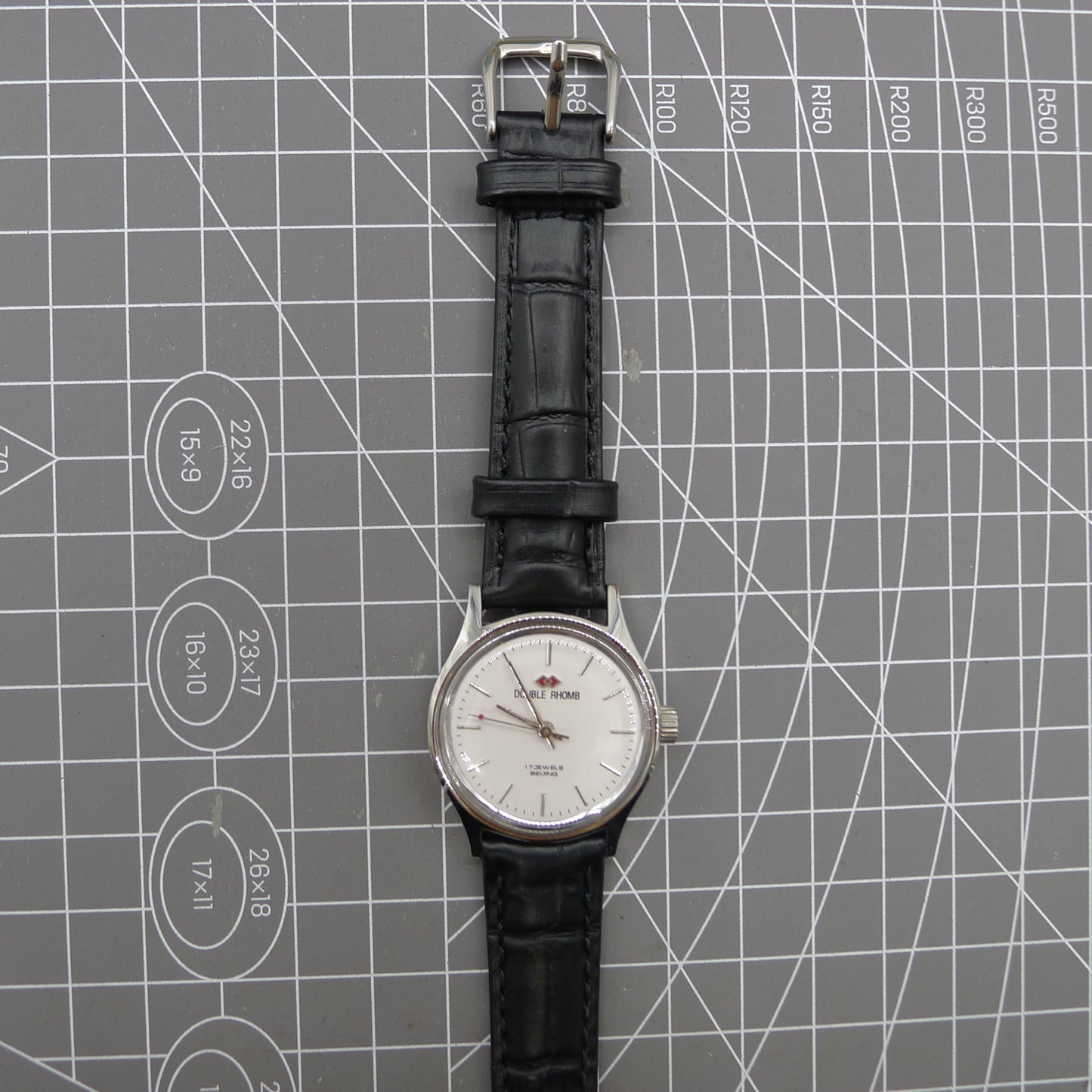 Beijing 31mm manual mechanical watch with silver case, double rhomb dial, showcasing classic Chinese craftsmanship.