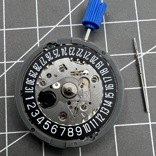 Seiko NH35A watch movement with black wheel, date at 6, 24 jewels for precision timekeeping.