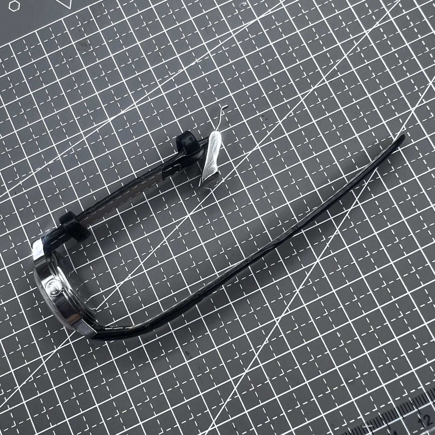 27mm Kongque watch with black leather strap, silver dial, gold markers, and manual mechanical movement.