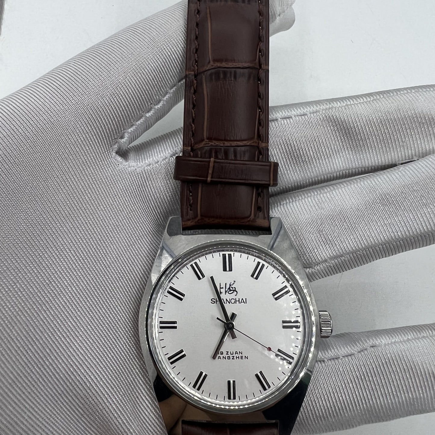 Shanghai Factory 38mm manual mechanical watch with white dial, 3 hands, and 19 jewels for accurate timekeeping.