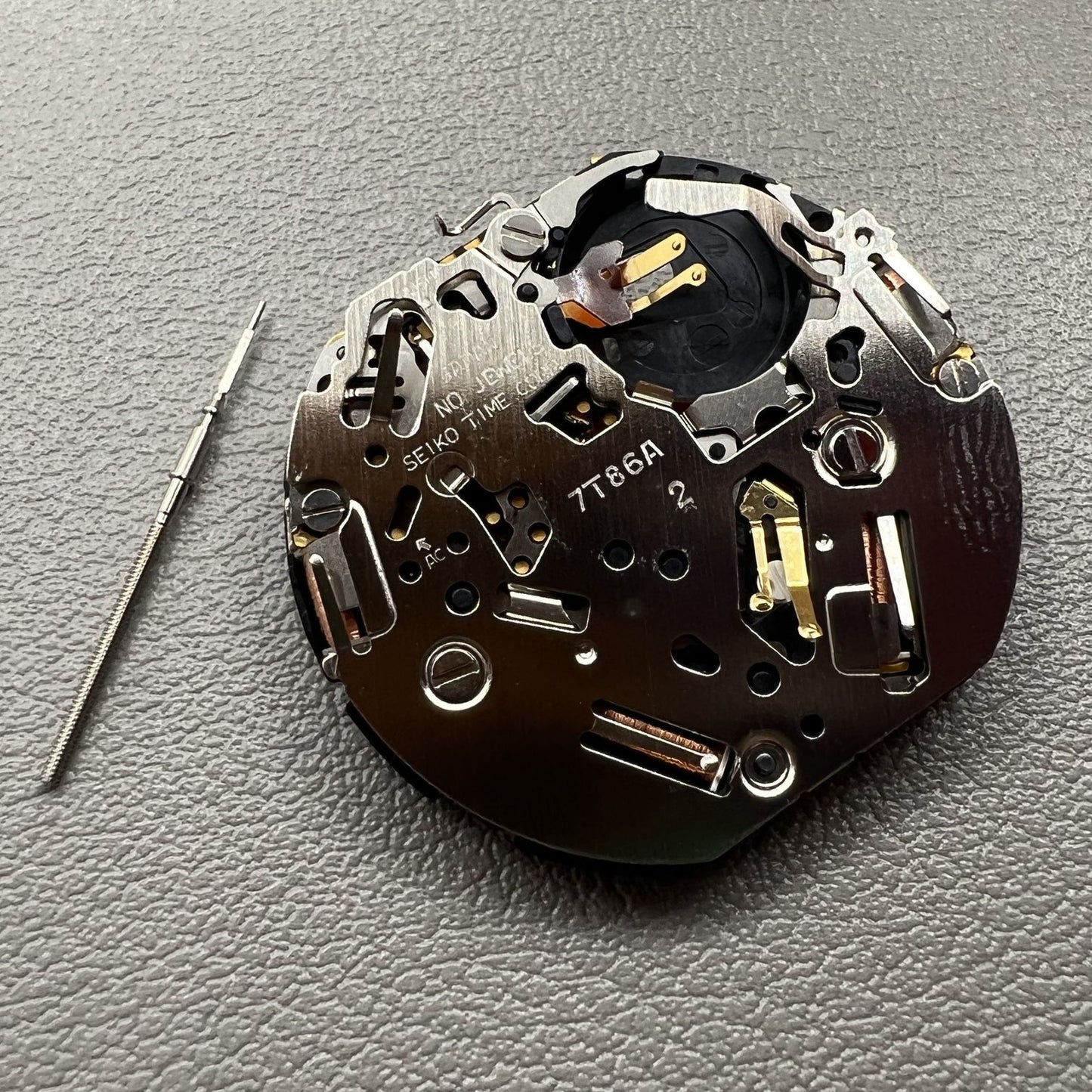 Seiko 7T86A quartz watch movement replacement part, precision Japanese craftsmanship for repairs.