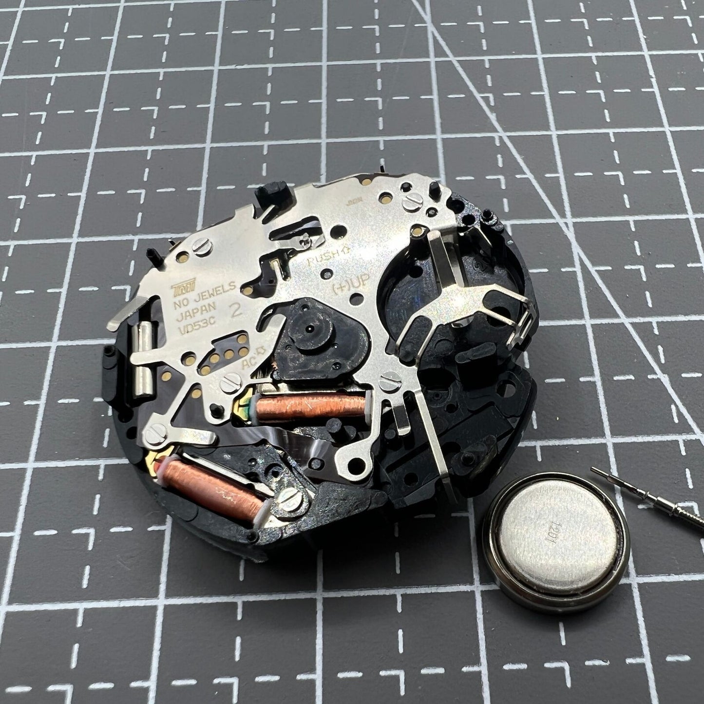 Hattori Epson VD53C quartz watch movement with date at 6 o'clock, Japanese precision timekeeping.