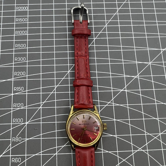 Seagull red dial Manual Mechanical Lady watch with gradient golden nails and single calendar display.