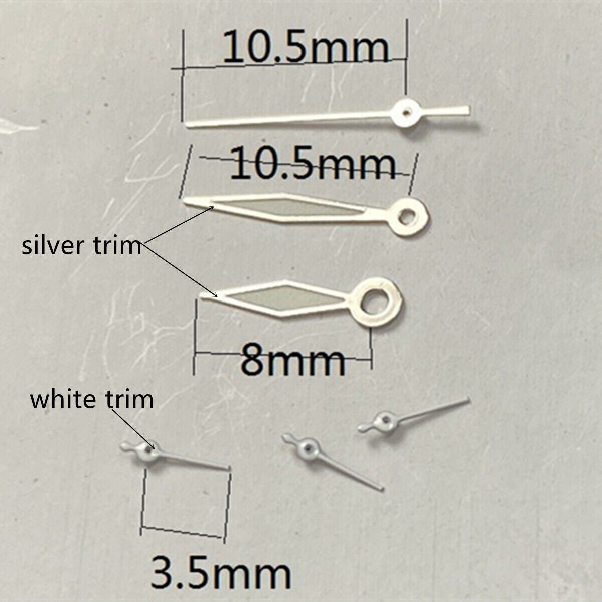 Silver and white trimmed watch hands with green lume, compatible with VD53, VD54, VD57 movements, branded.