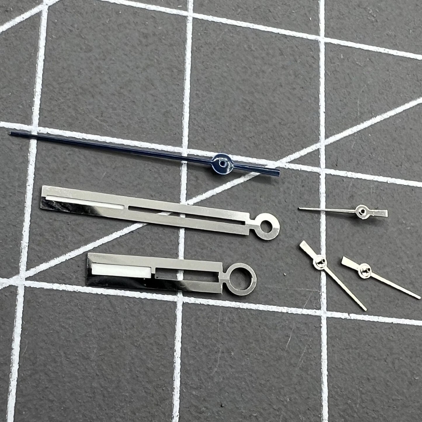 Silver luminous watch hands for Ronda 5021D, enhancing low-light readability on watch dials.