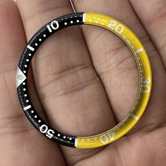 Black yellow circular arc bevel aluminum bezel insert for 39mm watch, enhancing style and durability.