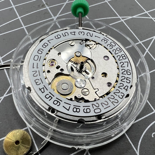 ETA 2824-2 Swiss mechanical movement close-up showing intricate watch mechanism details.