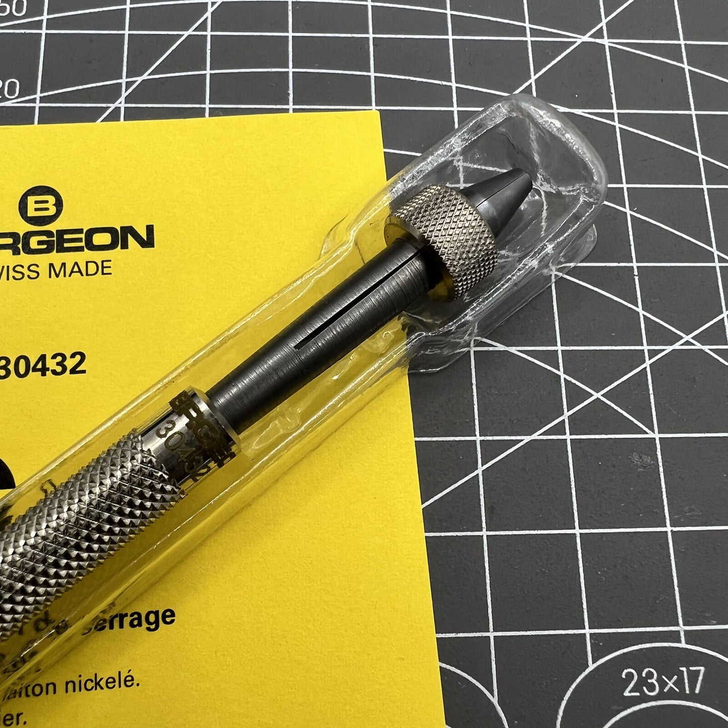 Bergeon 30432 pin vice with slide lock holding drills for precise watchmaking tasks.