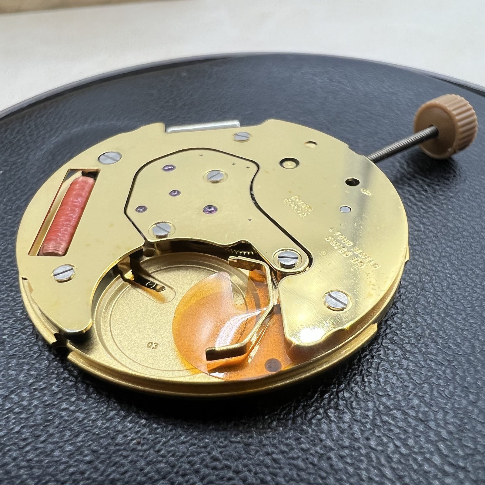 Swiss Ronda 6003.D quartz watch movement, black dial with 3 hands and single calendar, precise timekeeping.