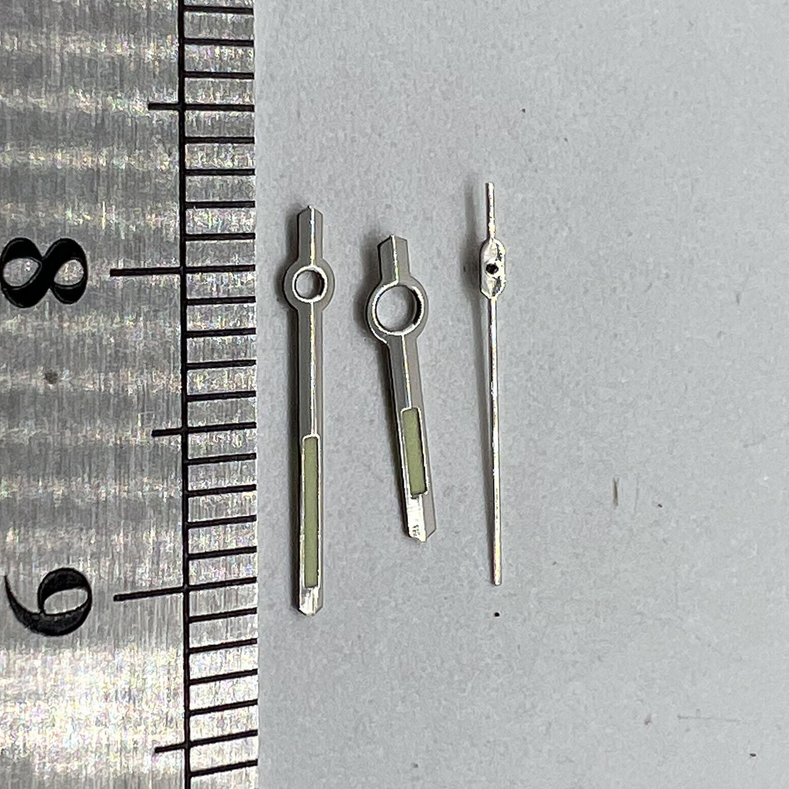 11mm silver trim green luminous watch hands for Orient 46941 movement, precise replacement parts enhancing visibility and style.