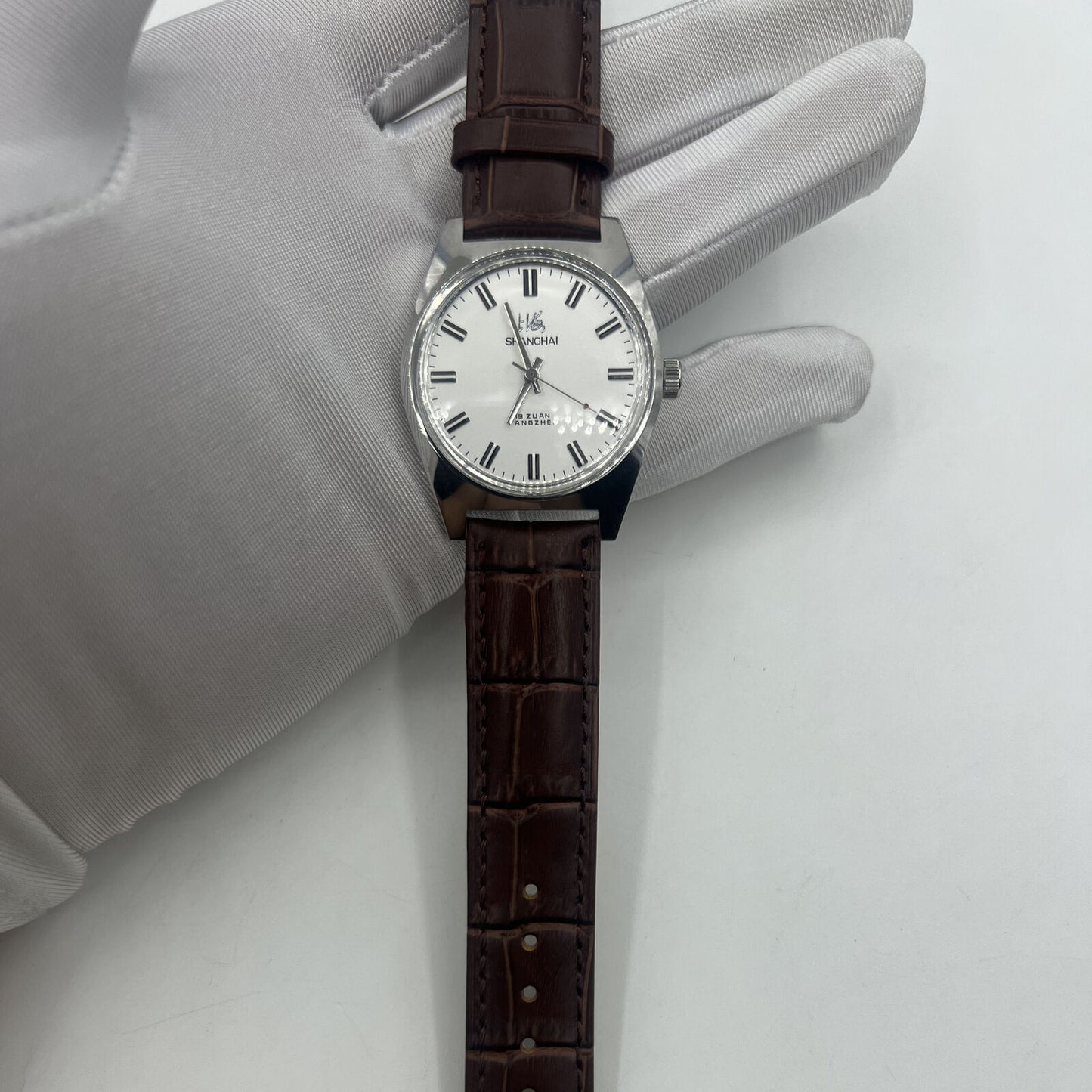 Shanghai Factory 38mm manual mechanical watch with white dial, 3 hands, and 19 jewels for precise timekeeping.