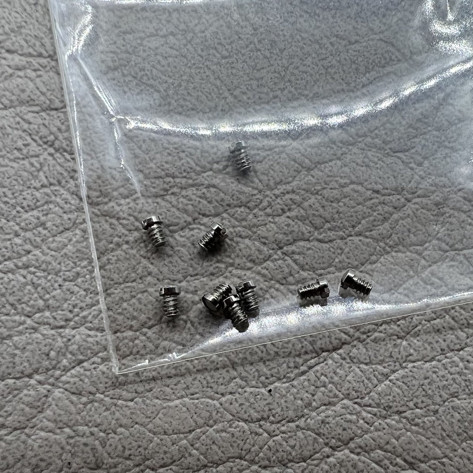 Set of 10 silver back cover screws for La Grande Classique De Longines L4 watch cases, durable replacement parts.