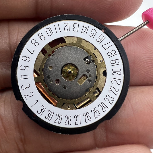 Ronda 715 Swiss Quartz watch movement with golden date window at 3 and 6 o'clock positions.