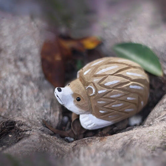 Handmade wooden hedgehog figurine, detailed lying sculpture for unique home decor.