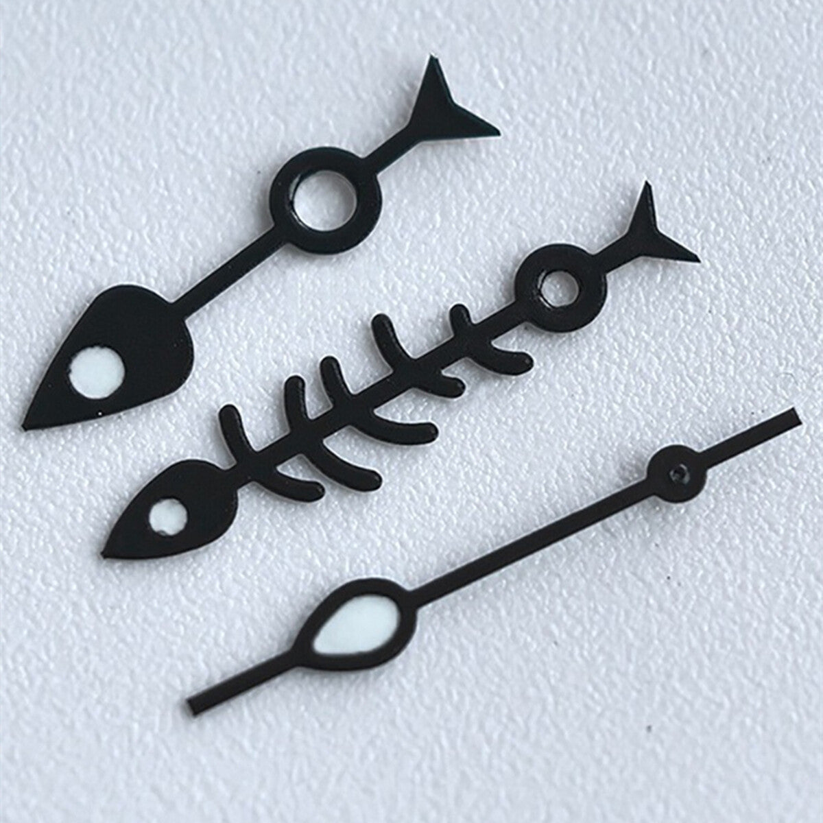 Matted black fish bone watch hands with white trim and green lume, designed for NH35 NH36 movements.