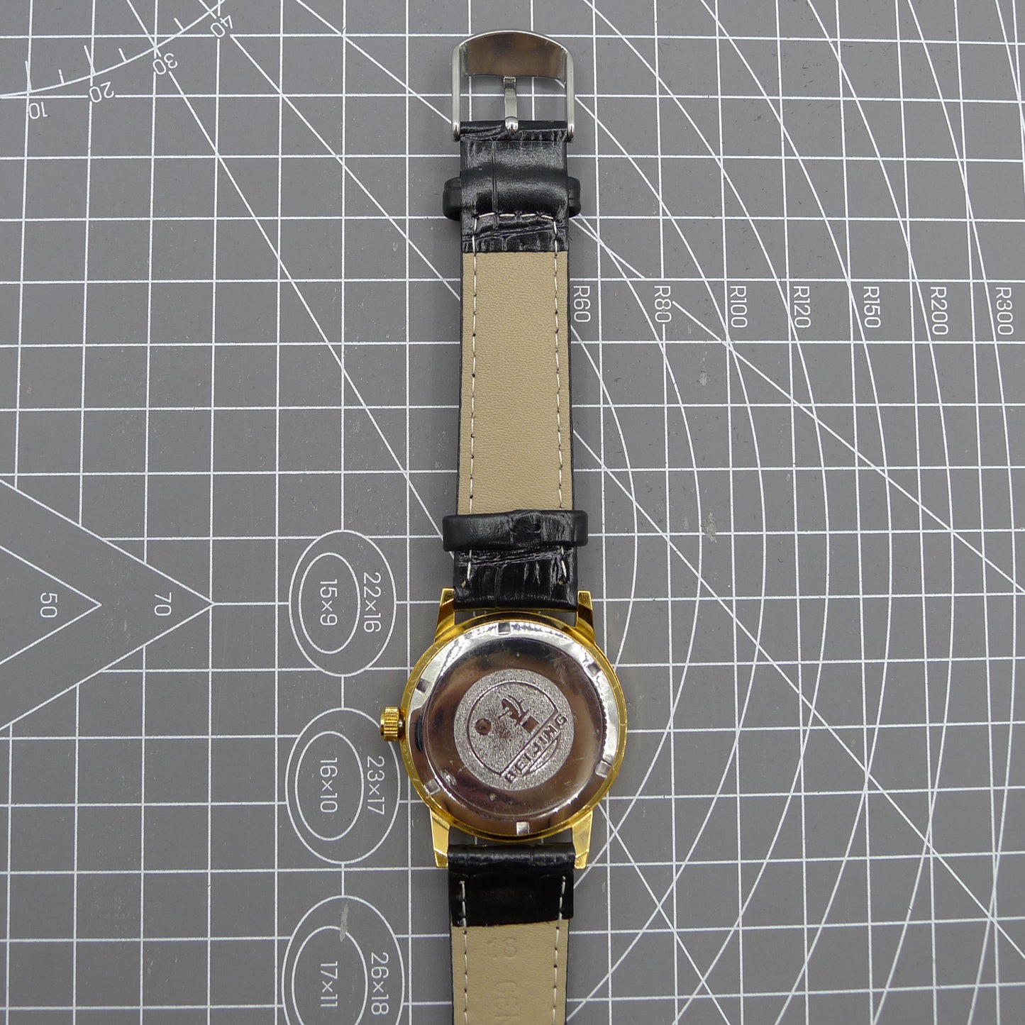 Beijing Double Rhomb mechanical watch, golden case with silver markers, elegant luxury timepiece.