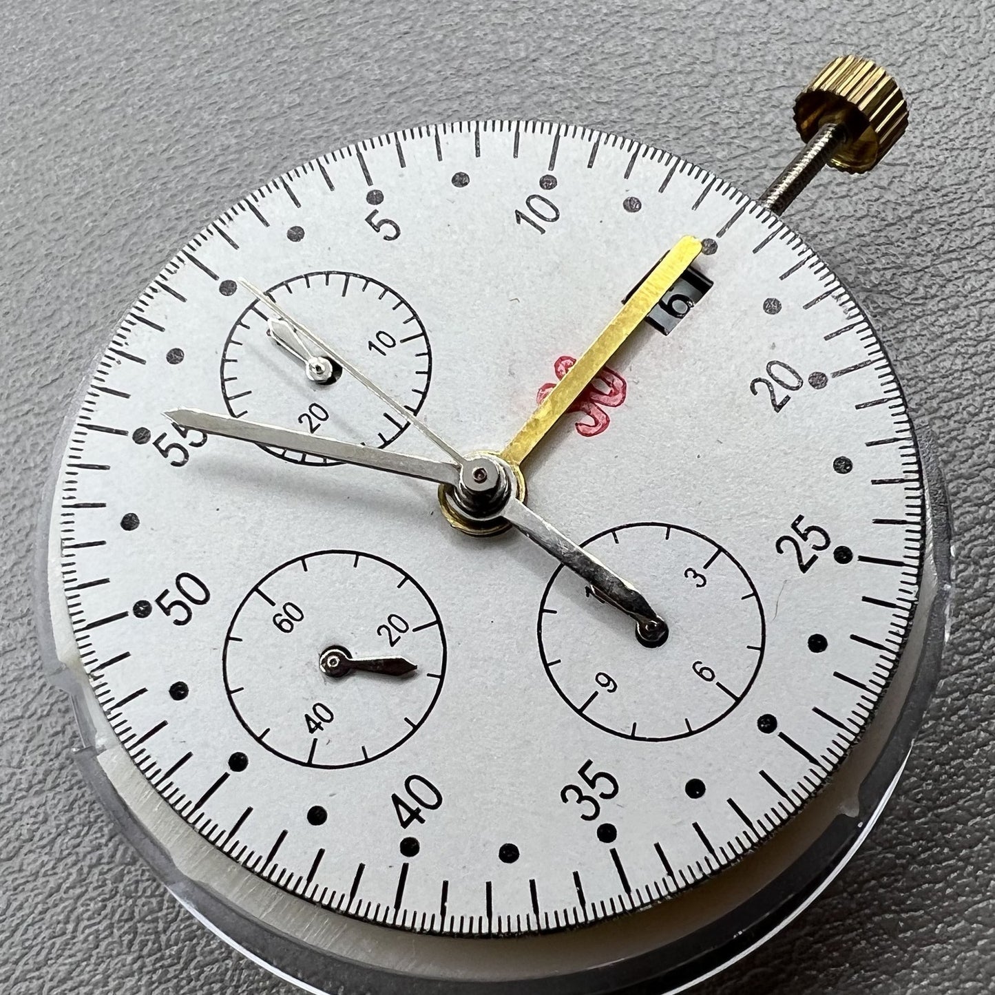 Dandong 7750 mechanical watch movement showing single calendar and small second subdials at 6, 9, and 12 o'clock
