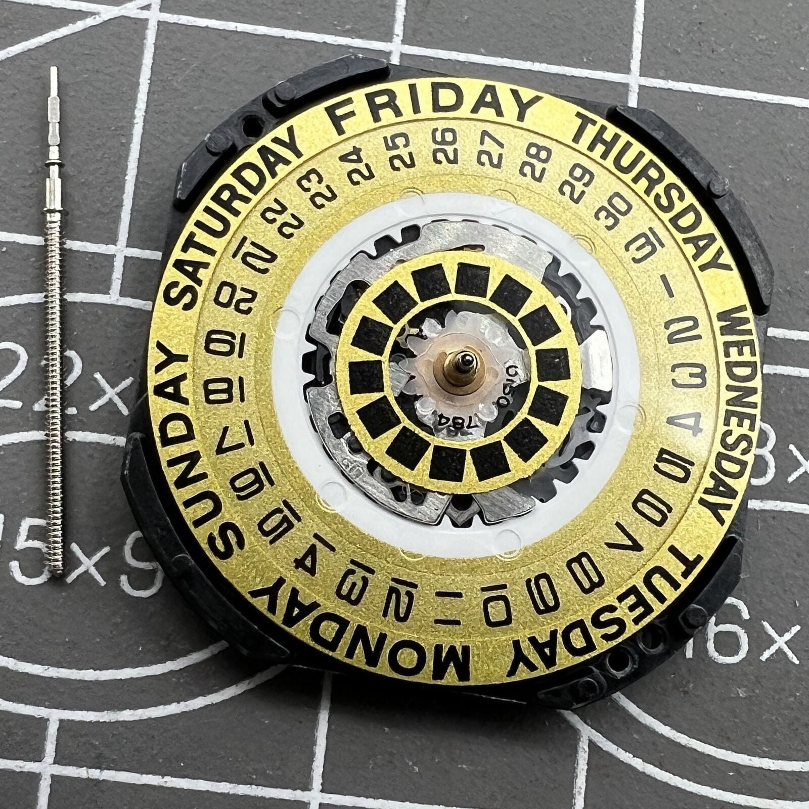 Hattori Epson TMI VX44E quartz watch movement with golden dial and date at 3 o'clock for precise timekeeping