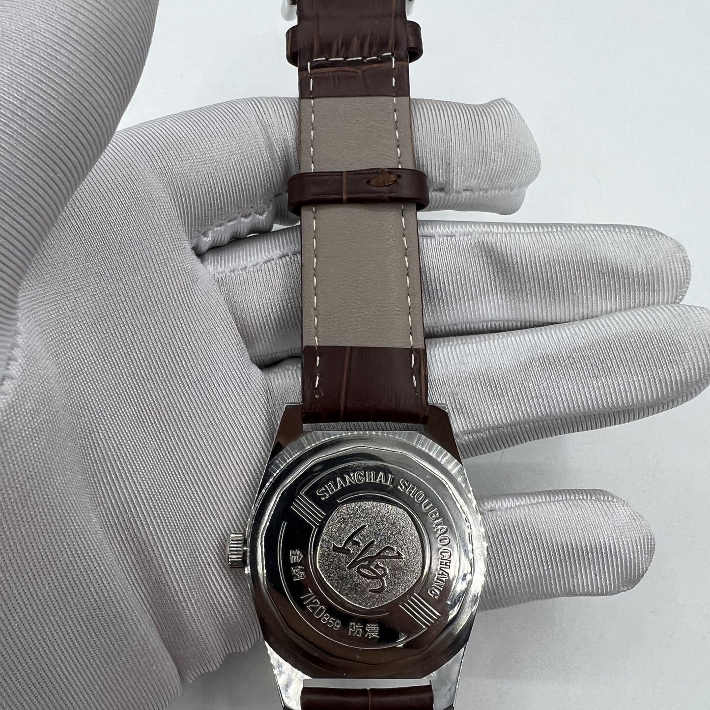 Shanghai Factory 38mm manual mechanical watch with white dial, 3 hands, and 19 jewels for precise timekeeping.