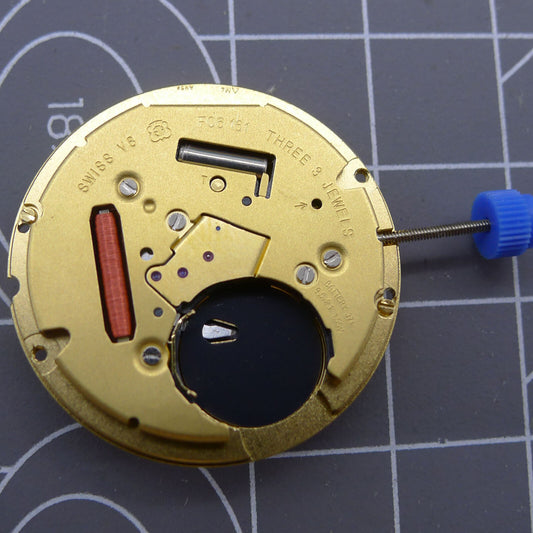 Swiss ETA F06.161 quartz watch movement with white dial, 3 hands, and date display at 6, for precise timekeeping.