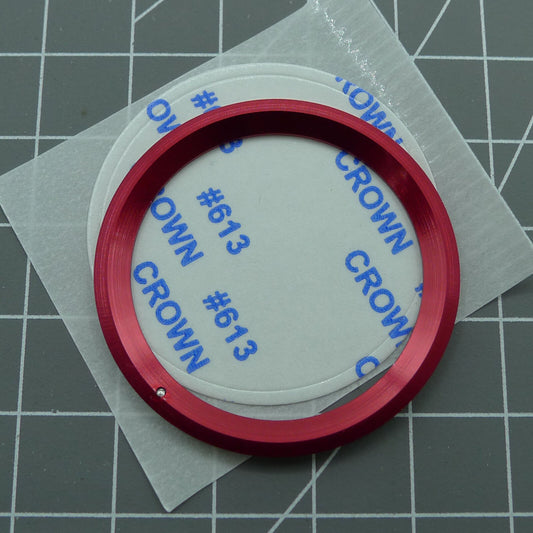 38mm ceramic watch bezel with red ring, silver font, and green luminous markers for bezel rotation.