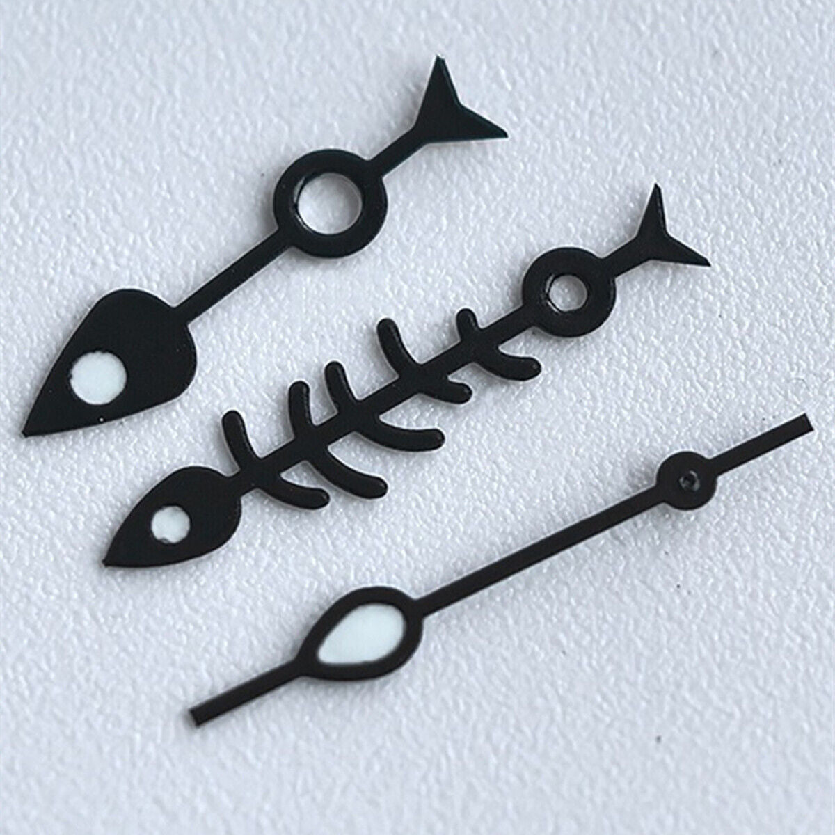 Matted black fish bone watch hands with white trim and green lume, designed for NH35 NH36 movements.