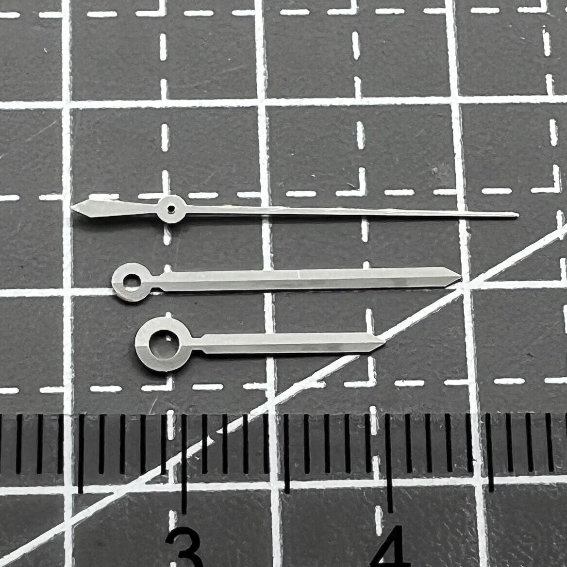 Silver watch hands set for ETAC07.111 movement, compatible with T099 watch, precision design.