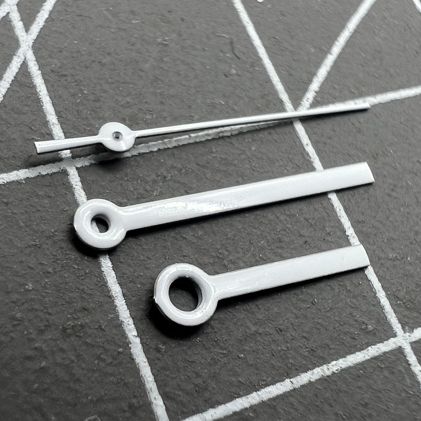 White watch hands set by Miyota, 15x13x9mm, compatible with 2035, 2115, 2105, 2305, 2315 movements, precise accessory for watch repair.