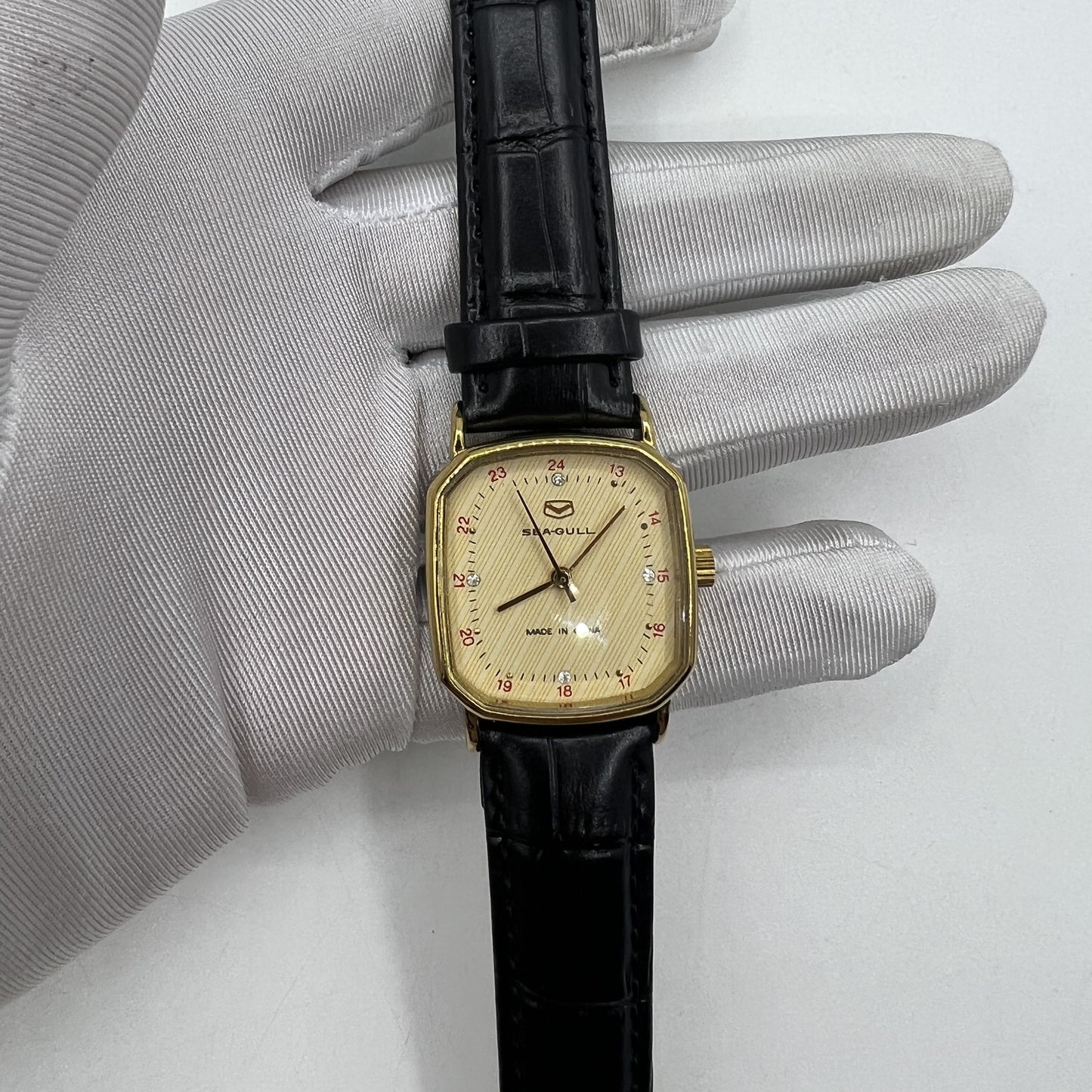 Seagull 28mm ladies watch with golden square case, manual mechanical movement, elegant for formal wear.