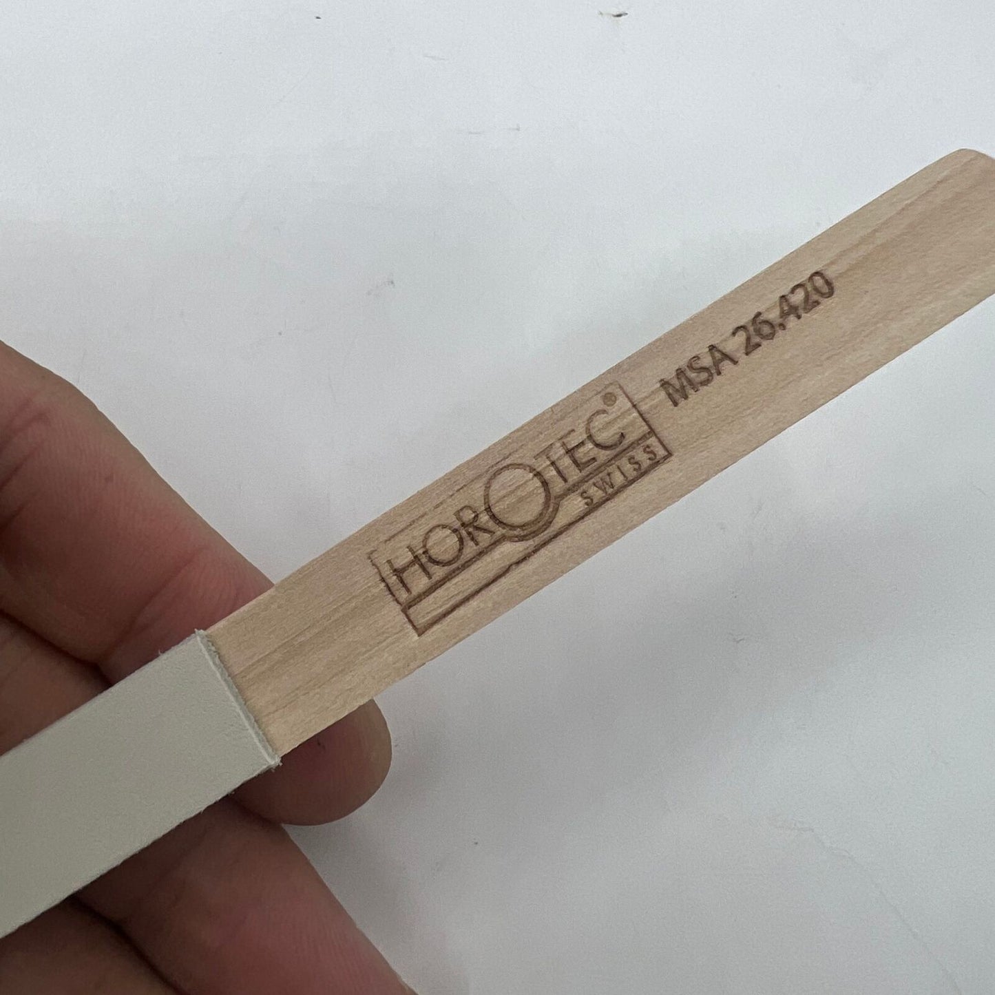 Horotec MSA26.420 white leather buff stick for watch polishing, precision Swiss watch accessory tool.