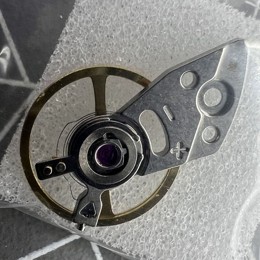 Silver balance wheel with splint for Miyota 8N24 watch movement, precision part made in Japan.