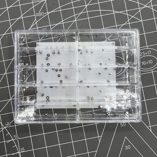 Assortment of fixing screws for watch movements in various sizes, perfect for precise repairs and assembly.