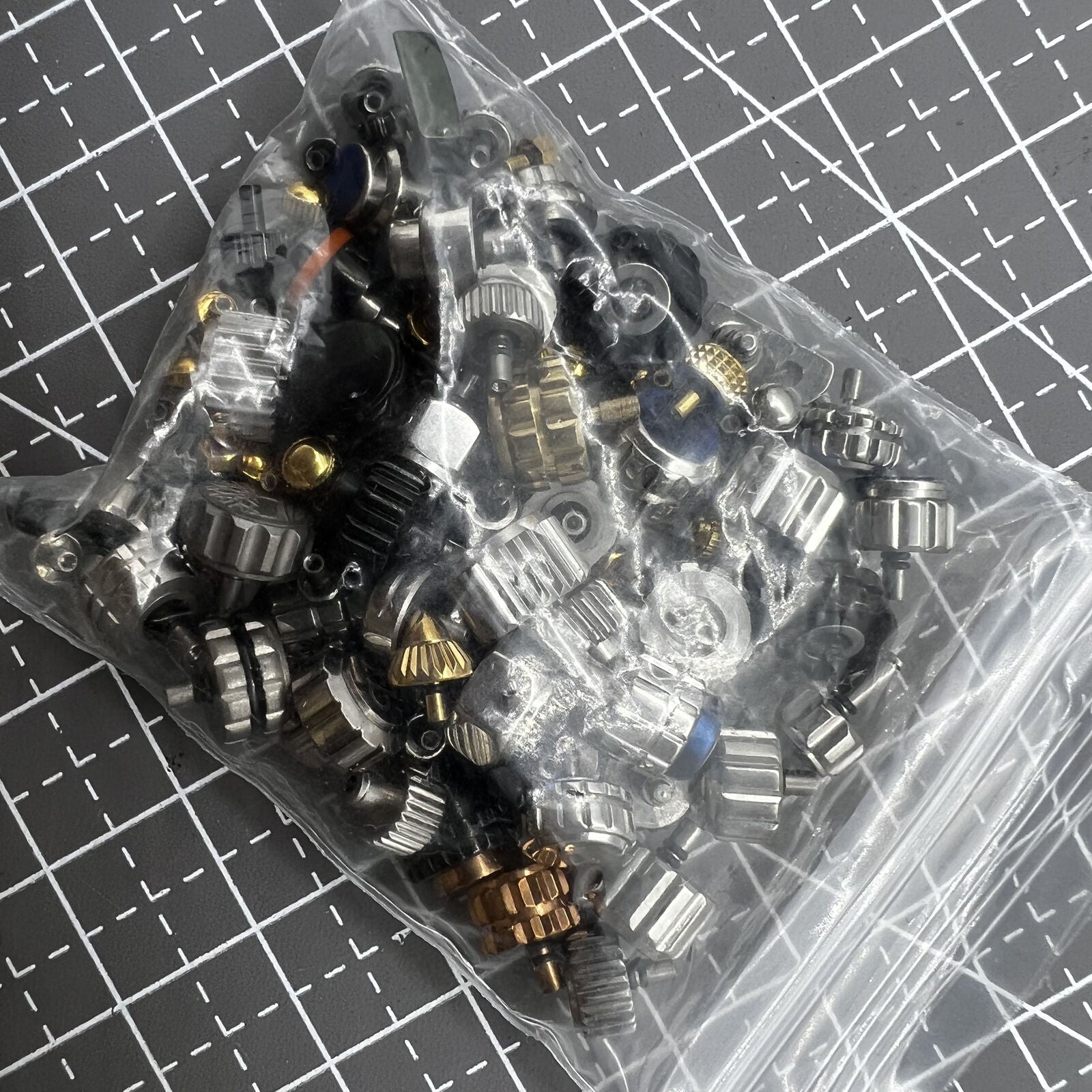 Assortment of 100 varied-size watch crowns for precise repairs and replacements.